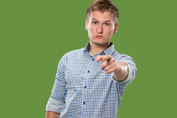 Image showing The overbearing businessman point you and want you, half length closeup portrait on green background.