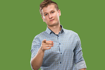 Image showing The overbearing businessman point you and want you, half length closeup portrait on green background.