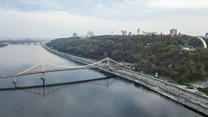 Image showing Aerial view of Bridge pedestrian across the Dnieper River, Embankment with traffic and the People\'s Friendship Arch on the mountain