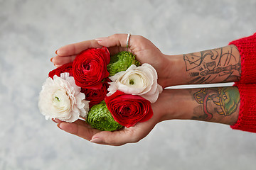 Image showing girl with a tattoo on her hands holding a bouquet of flowers