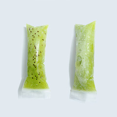 Image showing Green kiwi ice cream in vacuum plastic sticks on a gray background with copy space. Top view