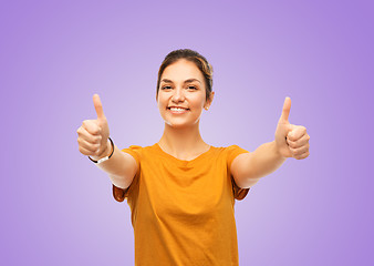 Image showing teenage girl in t-shirt showing thumbs up