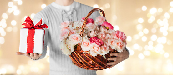 Image showing man with basket of flowers and gift over lights