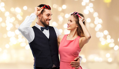 Image showing happy couple in heart-shaped sunglasses