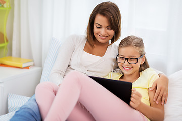 Image showing mother and daughter with tablet pc and earphones