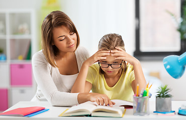 Image showing mother helping daughter with difficult homework