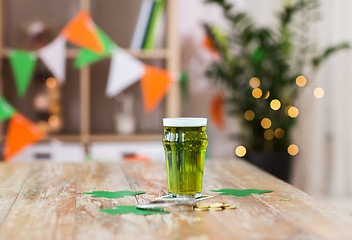 Image showing glass of green beer, horseshoe and golden coins