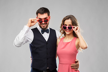 Image showing happy couple in heart-shaped sunglasses