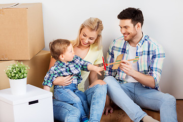 Image showing happy family with boxes moving to new home