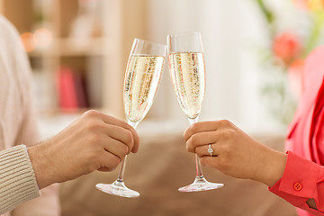 Image showing close up of couple clinking champagne glasses