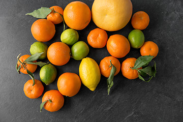 Image showing close up of citrus fruits on stone table