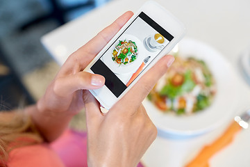 Image showing woman with smartphone photographing food at cafe