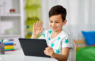 Image showing boy with tablet computer having video chat at home