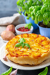 Image showing Traditional Tarte Tatin with potatoes and garlic.