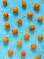 Image showing Ripe sweet apricots on a blue background.
