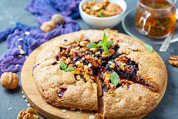 Image showing Cut Galette pie with black currant.