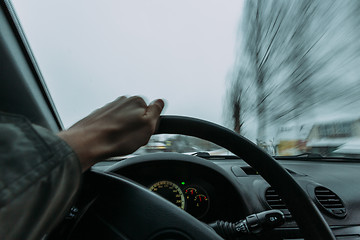 Image showing Riding behind the wheel of a car in winter