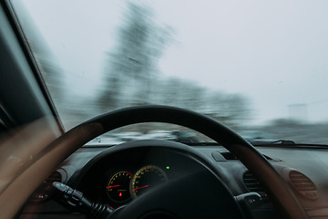 Image showing Riding behind the wheel of a car in winter