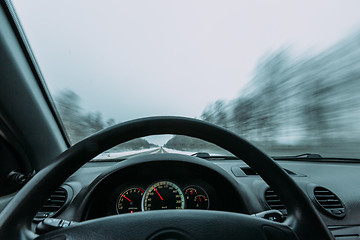 Image showing Riding behind the wheel of a car in winter