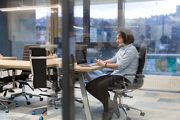 Image showing Young casual businessman using smartphone