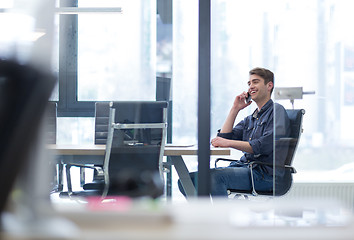 Image showing Young casual businessman using smartphone