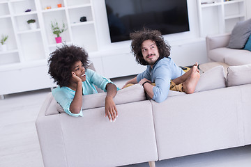 Image showing young multiethnic couple in living room