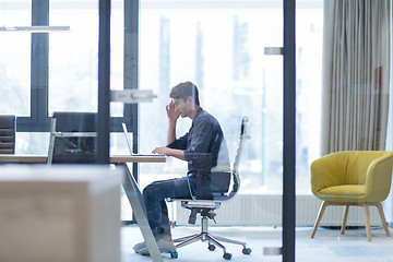 Image showing businessman working using a laptop in startup office