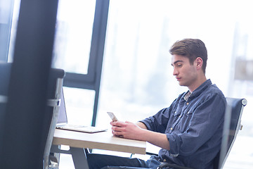 Image showing Young casual businessman using smartphone