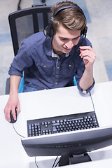 Image showing male call centre operator doing his job top view