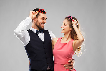 Image showing happy couple in heart-shaped sunglasses