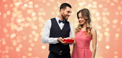 Image showing happy couple with chocolate box in shape of heart