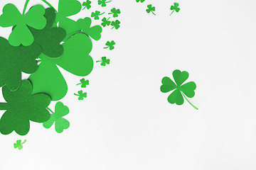 Image showing green paper shamrocks on white background