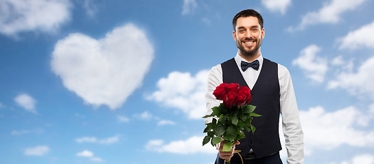 Image showing happy man with bunch of red roses