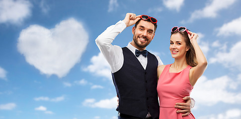 Image showing happy couple in heart-shaped sunglasses