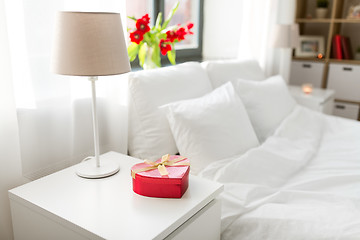 Image showing gift in shape of heart on bedside table in bedroom