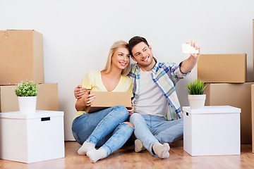 Image showing couple taking selfie and moving to new home