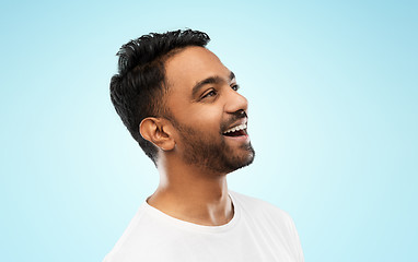 Image showing young laughing indian man over gray background