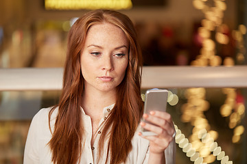 Image showing woman with smartphone at restaurant