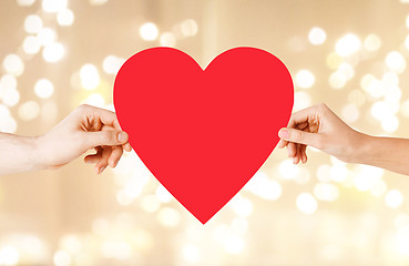 Image showing couple hands holding red heart