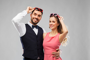 Image showing happy couple in heart-shaped sunglasses