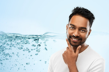 Image showing smiling indian man touching his beard