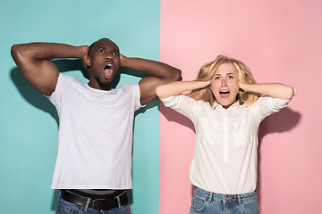 Image showing We won. Winning success happy afro man and woman celebrating being a winner. Dynamic image of caucasian female and male model on pink studio.