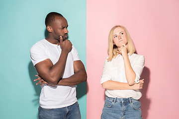 Image showing Young serious thoughtful businessman and woman. Doubt concept.