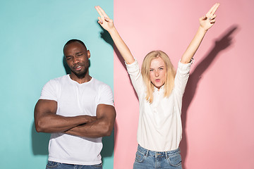 Image showing We won. Winning success happy afro man and woman celebrating being a winner. Dynamic image of caucasian female and male model on pink studio.