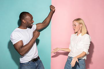 Image showing We won. Winning success happy afro man and woman celebrating being a winner. Dynamic image of caucasian female and male model on pink studio.