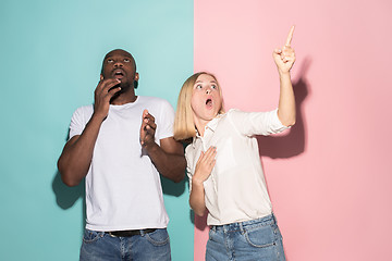 Image showing Portrait of the scared man and woman on pink and blue