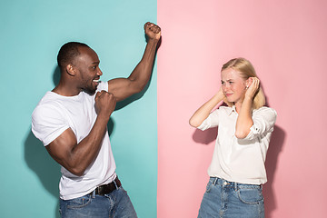 Image showing We won. Winning success happy afro man and woman celebrating being a winner. Dynamic image of caucasian female and male model on pink studio.