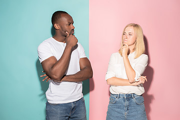 Image showing Young serious thoughtful businessman and woman. Doubt concept.