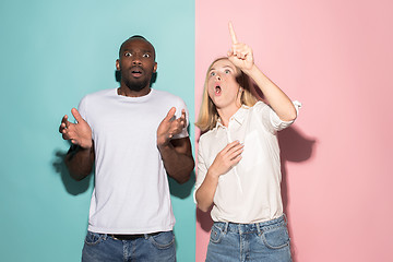 Image showing Portrait of the scared man and woman on pink and blue