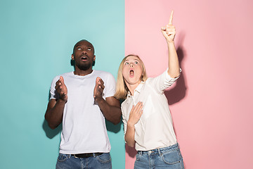 Image showing Portrait of the scared man and woman on pink and blue